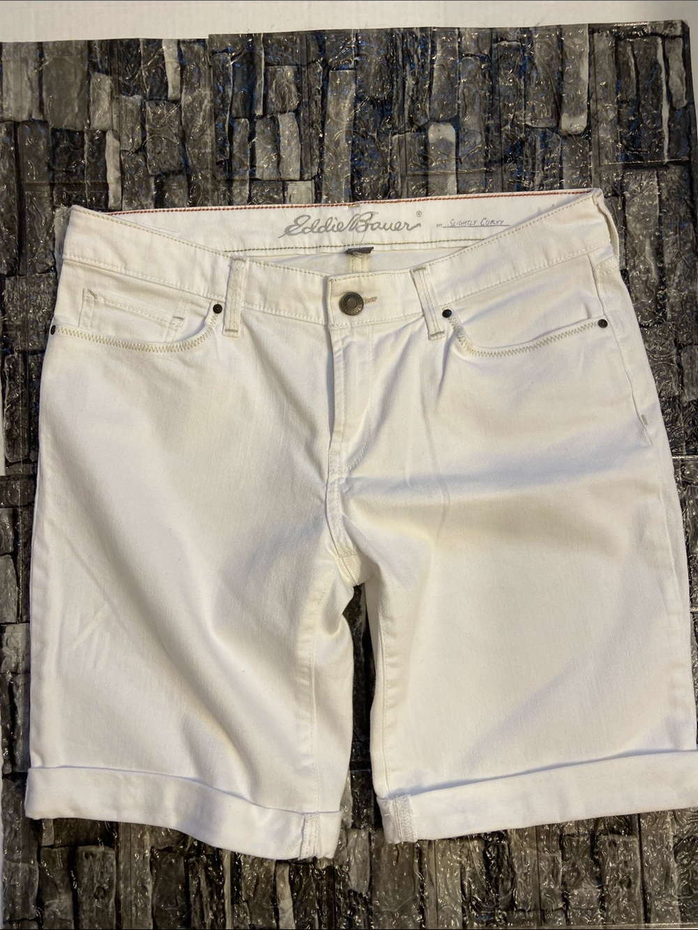 Eddie Bauer "Slightly Curvy" white denim shorts featuring a cuffed hem. NWOT